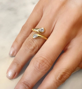 Close-up of a gold S925 sterling silver bypass ring with two zircon teardrop motifs