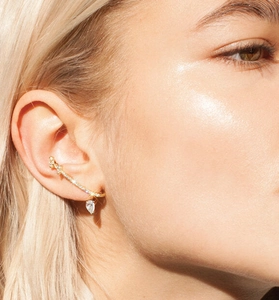 Detailed view of S925 silver ear cuff with paved stones and pear-cut zircon pendant