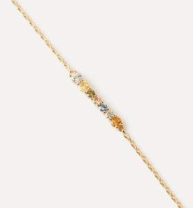 Detail of gold chain bracelet featuring seven colorful round gemstones in gradient hues