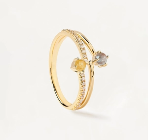 Macro detail of gold-plated two-tone ring with yellow and grey stones and pavé diamonds