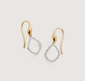 Detailed view of hollow teardrop earrings with gold plating and paved white zircons