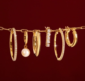 S925 silver gold earrings set with pearls and zircons on red festive background