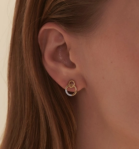 Detail of S925 silver double hoop earrings with gold finish and sparkling pavé crystals