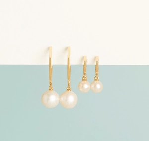 Detail of two pairs of S925 silver pearl drop earrings in gold finish and white pearls