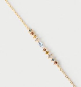 Macro shot of gold chain link bracelet with multi-color zircon stones in various cuts