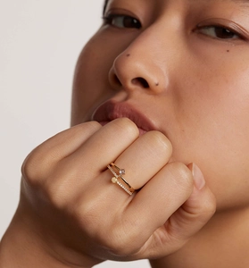 Close-up of stacked S925 silver rings with round grey gemstone and pavé zircon details