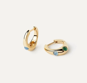 Detail of gold hoop earrings with inset purple and green faceted zircon stones