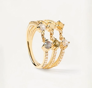 Detailed macro view of three gold rings with multi-color zircon charms and pavé stones