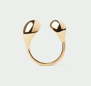 Macro shot of polished gold-plated open ring with smooth asymmetric teardrop spheres