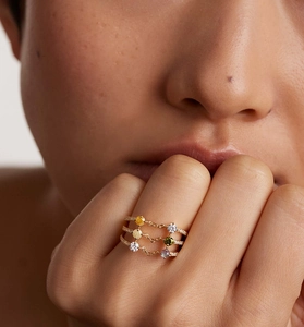 Detail of gold multi-layer chain ring with colorful gemstones and micro-pave diamonds
