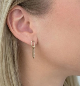 Close-up of elegant double oval link earrings with sparkling zircons in gold plating