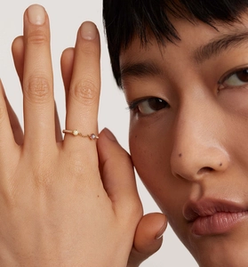 Detail of S925 silver gold-plated chain ring with yellow and purple zircon stones