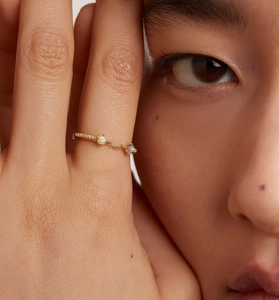 Detail of S925 silver gold-plated ring with zircon chain link on model's finger