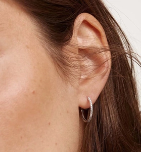 Close-up of S925 silver hoop earrings with micro-paved sparkling zircon stones on model