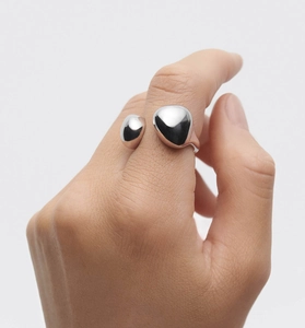 Close-up of polished S925 sterling silver asymmetrical open ring on hand