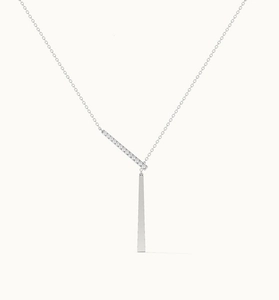 Macro detail of S925 sterling silver Y-necklace with zircon bar and polished cone pendant