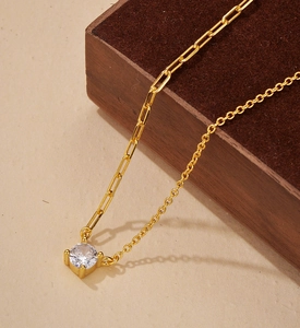 Detail of S925 silver necklace with zircon stone and gold paperclip chain