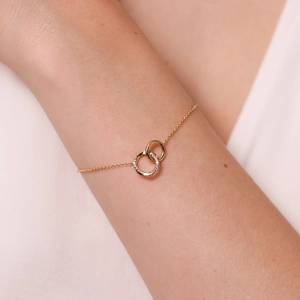 Elegante bracciale in argento 925 dorato con doppi anelli intrecciati e pavé di zirconi