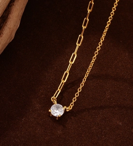 Macro detail of gold S925 silver necklace with zircon pendant and paperclip chain links