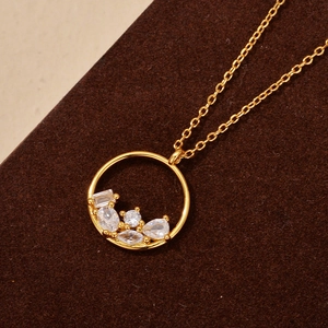 Elegant gold necklace with circular pendant featuring multi-shape cubic zirconia stones