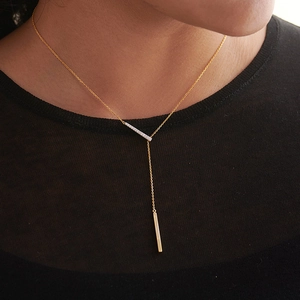 Elegant gold S925 geometric Y-necklace featuring a pavé zircon bar and polished pendant