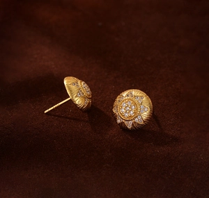 Macro shot of 18K gold plated S925 silver stud earrings with sunflower grid and zircons