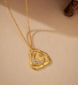 Detailed close-up of S925 silver moon pendant with hammered texture and sparkling stones