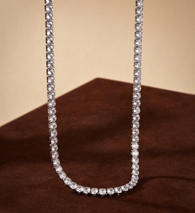 Macro view of a classic S925 silver tennis necklace with sparkling round-cut crystals