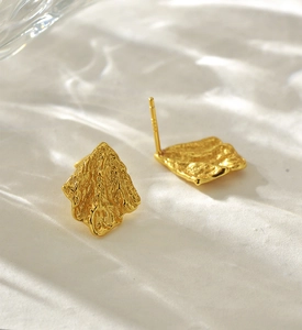 Vue détaillée de boucles d'oreilles dorées froissées avec tige en argent S925