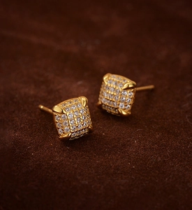 Macro shot of gold plated square stud earrings with pavé set cubic zirconia stones