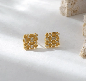 Macro view of gold S925 silver square earrings with woven texture and micro diamonds