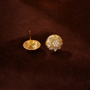 Macro view of 18K gold-plated sterling silver sunflower stud earrings with zircon stones