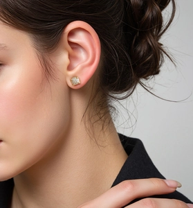 Close-up of 18K gold plated square zircon stud earring on ear for luxury look