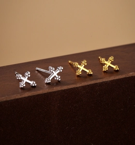 Detailed close-up of S925 sterling silver cross stud earrings with fine hallmarking