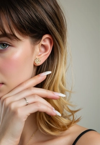 Macro detail of geometric 18K gold plated square earrings with pavé set zircon stones