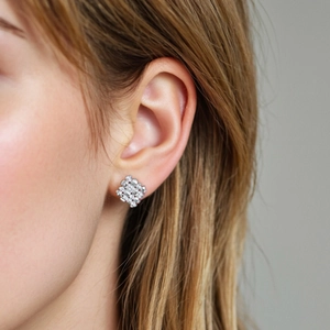 S925 sterling silver geometric diamond stud earrings worn by a model in a close-up view