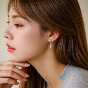 Elegant S925 sterling silver butterfly earrings with long tassel drops on a female model