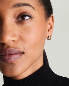 Gros plan de boucles d'oreilles créoles en forme de C bicolores or et argent à deux couches