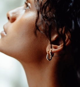 Close-up of modern two-tone U-shaped silver earring on a model for a stylish minimalist look