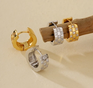 Close-up of S925 sterling silver huggie earrings with zircon checkered patterns