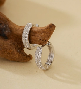 Macro shot of silver plated hoop earrings with micro pave white zircon settings