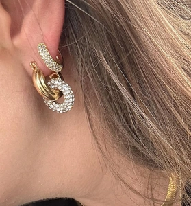 Macro shot of gold S925 silver hoop earrings with pavé zircon stones and a minimalist finish
