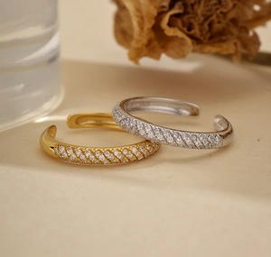 Detailed view of gold and silver S925 sterling silver open rings with pavé zircon stones