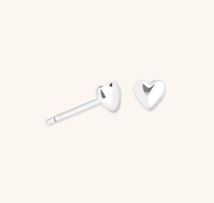 Macro shot of minimalist S925 sterling silver heart stud earrings with polished finish
