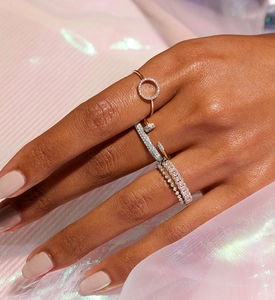 Macro detail of 925 silver stacked rings set featuring crystal pavé and nail design