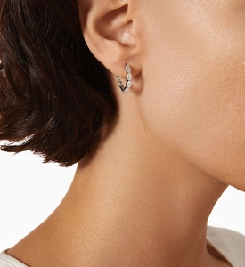 Detail of S925 silver hoop earrings with a row of pear-cut sparkling zircon stones