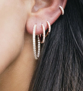 Close-up of stacked S925 sterling silver hoop earrings with pavé set zirconia crystals
