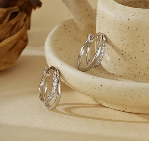 Detail of 925 sterling silver double hoop earrings with sparkling micro-inlaid zircons