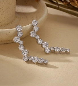 Detail view of S925 sterling silver S-shaped earrings with round pavé zirconia stones