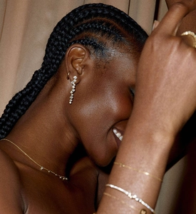 Close-up of elegant S925 sterling silver drop earrings with pavé diamonds on a model